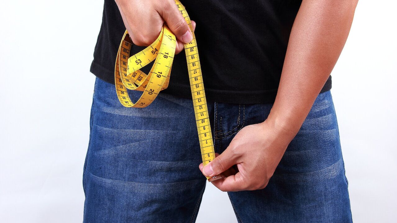 man measuring penis before enlarging it